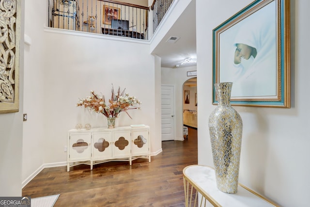 312 Sierra Ct, Mcdonough, GA 30253 - hall featuring arched walkways, wood finished floors, and a high ceiling