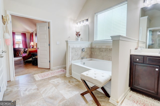 312 Sierra Ct, Mcdonough, GA 30253 - ensuite bathroom featuring lofted ceiling, a bath, and vanity
