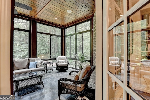 272 Lake Forrest Ln NE, Atlanta, GA 30342 - sunroom / solarium featuring stone tile floors, plenty of natural light, wooden ceiling, a wall of windows, and an outdoor hangout area