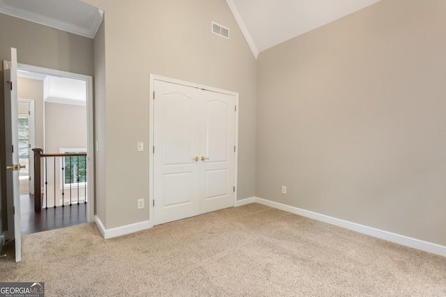 110 Wellington Way, Canton, GA 30115 - unfurnished bedroom featuring carpet floors, crown molding, lofted ceiling, and a closet