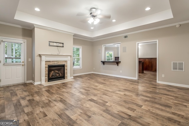 110 Wellington Way, Canton, GA 30115 - unfurnished living room with a raised ceiling, a ceiling fan, wood finished floors, ornamental molding, and healthy amount of natural light