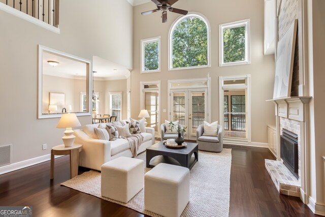 110 Wellington Way, Canton, GA 30115 - living room with ceiling fan, dark wood-type flooring, crown molding, a brick fireplace, and a high ceiling