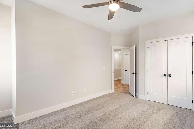 148 Palm St, Holly Springs, GA 30115 - unfurnished bedroom featuring carpet flooring, a closet, and a ceiling fan