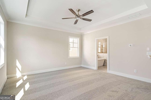 148 Palm St, Holly Springs, GA 30115 - empty room featuring a raised ceiling, light colored carpet, and a ceiling fan