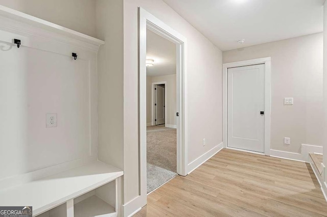148 Palm St, Holly Springs, GA 30115 - mudroom with light wood finished floors and baseboards