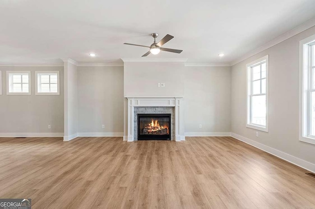 148 Palm St, Holly Springs, GA 30115 - unfurnished living room with ornamental molding, a ceiling fan, plenty of natural light, a stone fireplace, and light wood-style flooring