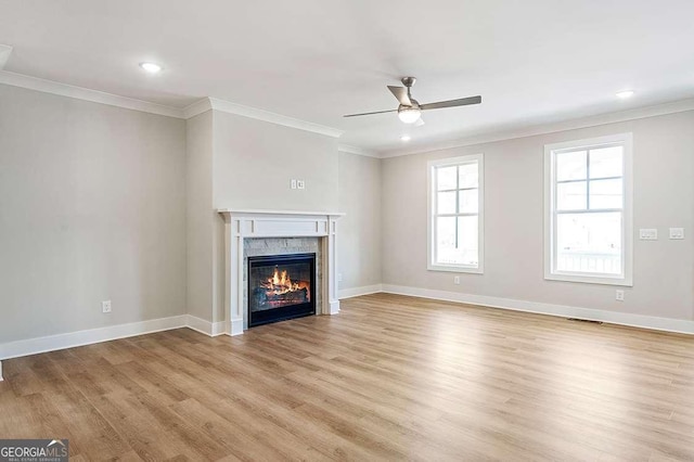 148 Palm St, Holly Springs, GA 30115 - unfurnished living room with ceiling fan, light wood-style flooring, ornamental molding, a glass covered fireplace, and recessed lighting