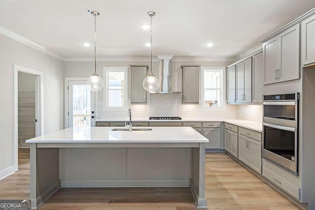 148 Palm St, Holly Springs, GA 30115 - kitchen with gray cabinets, double oven, tasteful backsplash, wall chimney range hood, and light countertops