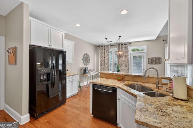 43 Emily Ln, Bogart, GA 30622 - kitchen featuring black appliances, white cabinetry, light stone counters, light wood-style floors, and recessed lighting
