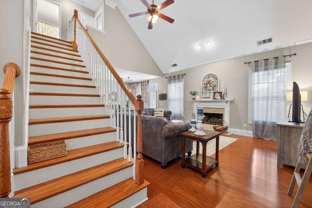 43 Emily Ln, Bogart, GA 30622 - living area featuring stairs, a ceiling fan, wood finished floors, a fireplace, and high vaulted ceiling