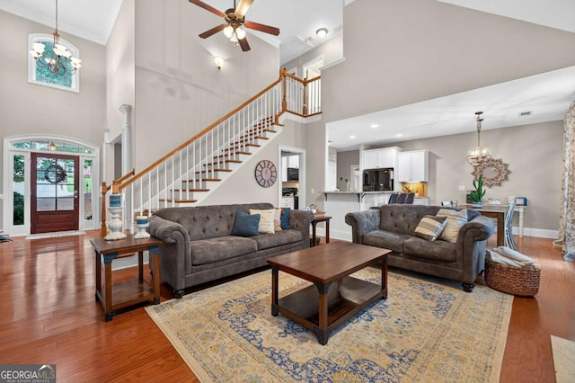 43 Emily Ln, Bogart, GA 30622 - living room with a towering ceiling, a chandelier, wood finished floors, ceiling fan, and ornamental molding