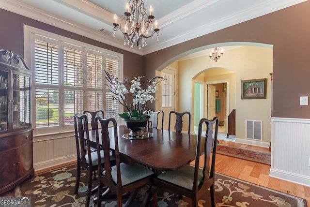 1071 Creekwood Cir, Madison, GA 30650 - dining area with arched walkways, a chandelier, wood finished floors, wainscoting, and crown molding