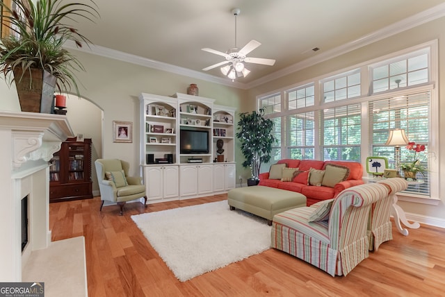 1071 Creekwood Cir, Madison, GA 30650 - living area with a fireplace with flush hearth, light wood-style floors, ornamental molding, and ceiling fan