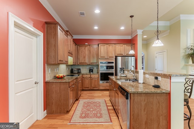 1071 Creekwood Cir, Madison, GA 30650 - kitchen featuring appliances with stainless steel finishes, ornamental molding, light wood finished floors, recessed lighting, and a kitchen bar