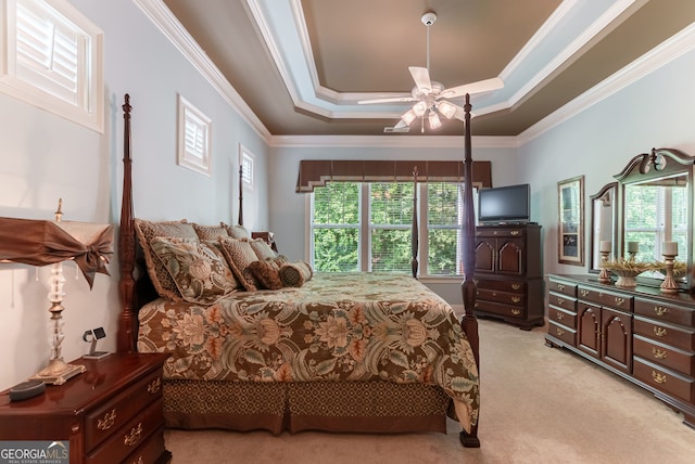 1071 Creekwood Cir, Madison, GA 30650 - bedroom featuring light colored carpet, ornamental molding, multiple windows, ceiling fan, and a raised ceiling