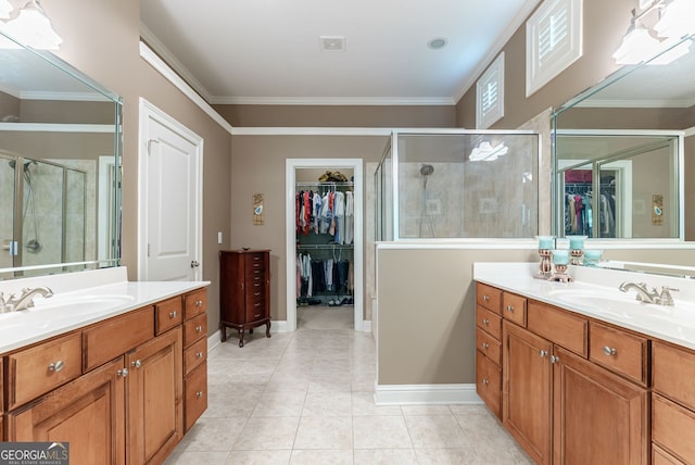 1071 Creekwood Cir, Madison, GA 30650 - bathroom with two vanities, a walk in closet, a shower stall, crown molding, and tile patterned flooring
