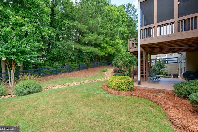 1071 Creekwood Cir, Madison, GA 30650 - fenced backyard with stairway, a patio, a wooden deck, and a sunroom