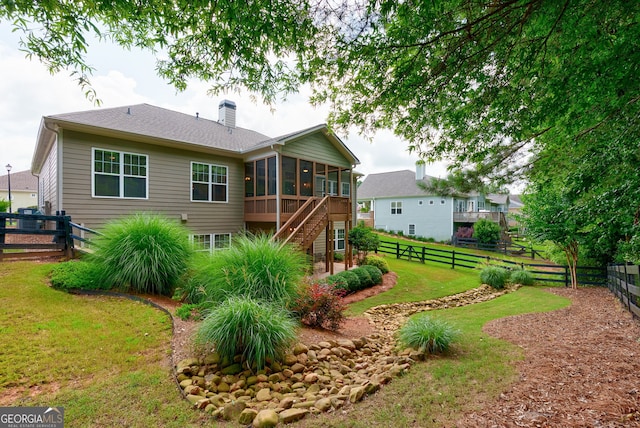 1071 Creekwood Cir, Madison, GA 30650 - rear view of house featuring a sunroom, a chimney, a fenced backyard, and stairs