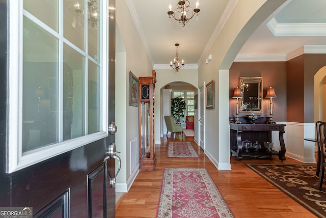 1071 Creekwood Cir, Madison, GA 30650 - entrance foyer with arched walkways, a chandelier, light wood-type flooring, and ornamental molding