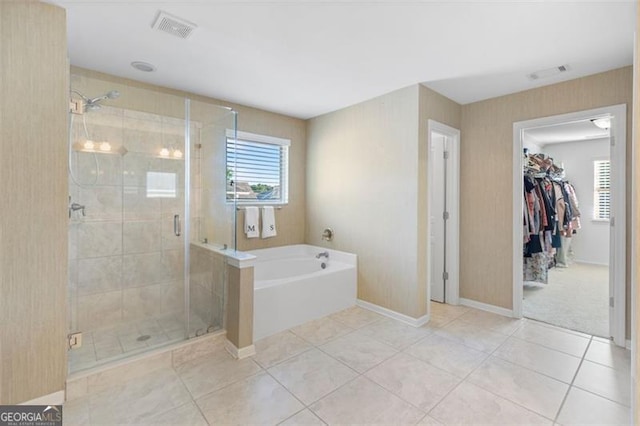 109 Hale View Cir, Canton, GA 30114 - bathroom featuring a garden tub, a stall shower, a walk in closet, and tile patterned floors