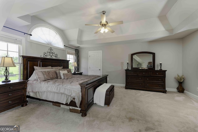 481 Fields Ferry Dr NE, Calhoun, GA 30701 - bedroom with multiple windows, light colored carpet, a ceiling fan, a tray ceiling, and vaulted ceiling