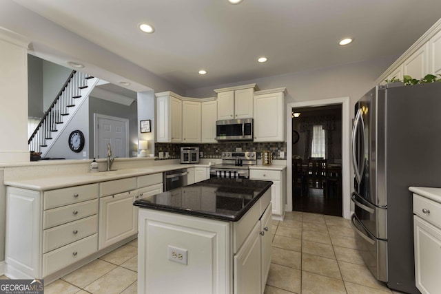 481 Fields Ferry Dr NE, Calhoun, GA 30701 - kitchen featuring appliances with stainless steel finishes, decorative backsplash, light tile patterned flooring, recessed lighting, and a kitchen island