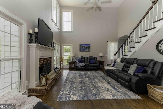 481 Fields Ferry Dr NE, Calhoun, GA 30701 - living area featuring a high ceiling, wood finished floors, stairway, a fireplace, and a ceiling fan