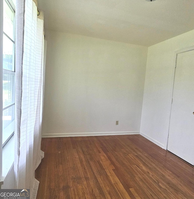 1055 Scruggs Cir, Bartow, GA 30413 - unfurnished bedroom with wood finished floors and multiple windows