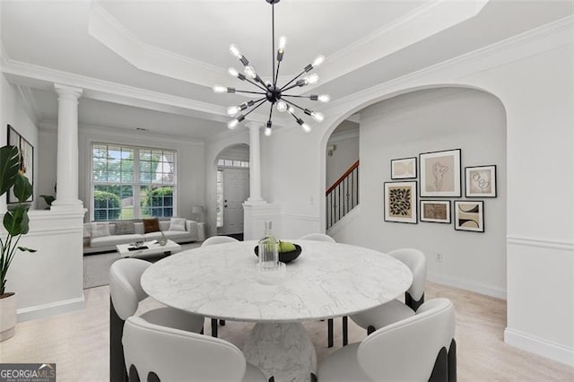 3366 Bridge Walk Dr, Lawrenceville, GA 30044 - dining area featuring decorative columns, arched walkways, stairway, light wood-style floors, and ornamental molding