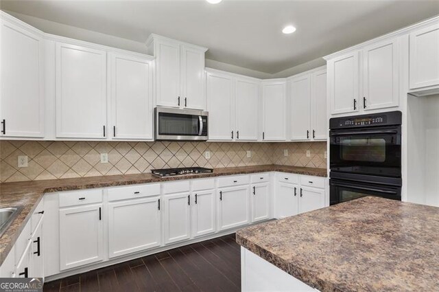 3366 Bridge Walk Dr, Lawrenceville, GA 30044 - kitchen with stainless steel appliances, white cabinetry, dark countertops, dark wood finished floors, and recessed lighting