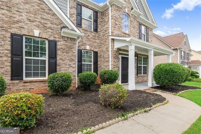 3366 Bridge Walk Dr, Lawrenceville, GA 30044 - view of exterior entry featuring brick siding and covered porch