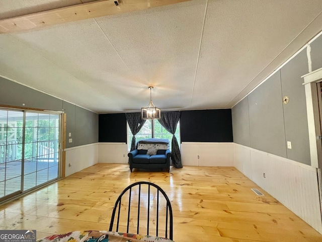 906 Billy Watts Cove Rd, Tiger, GA 30576 - unfurnished room with hardwood / wood-style floors, plenty of natural light, wainscoting, and a textured ceiling