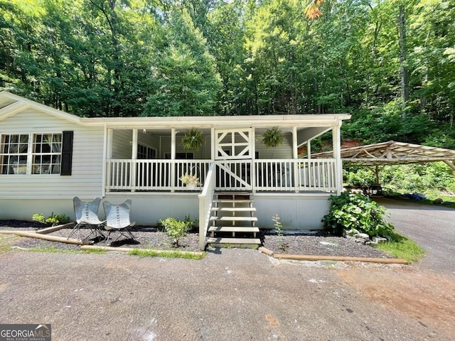 906 Billy Watts Cove Rd, Tiger, GA 30576 - manufactured / mobile home with covered porch, asphalt driveway, and a carport