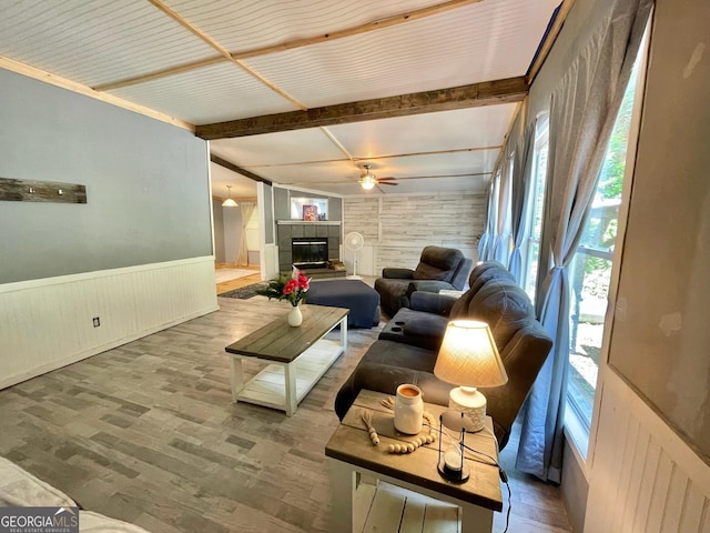 906 Billy Watts Cove Rd, Tiger, GA 30576 - living room with beam ceiling, a wainscoted wall, wooden walls, a ceiling fan, and wood finished floors