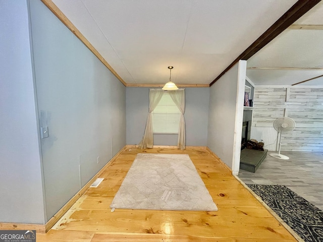 906 Billy Watts Cove Rd, Tiger, GA 30576 - unfurnished dining area with wood finished floors, a fireplace, and crown molding
