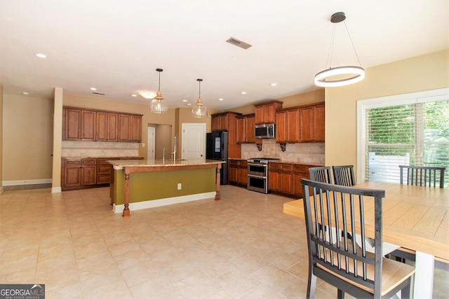 10 Ridgeview Ct, Newnan, GA 30263 - kitchen with appliances with stainless steel finishes, brown cabinets, tasteful backsplash, and recessed lighting