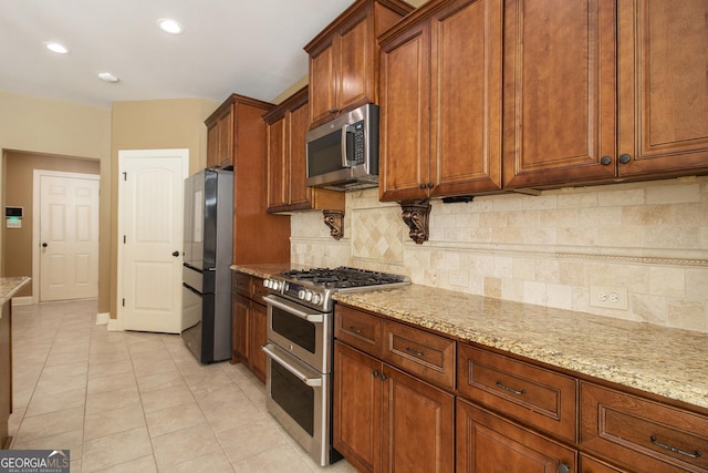 10 Ridgeview Ct, Newnan, GA 30263 - kitchen featuring stainless steel appliances, light stone countertops, light tile patterned flooring, decorative backsplash, and recessed lighting
