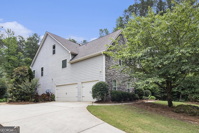 10 Ridgeview Ct, Newnan, GA 30263 - view of side of home with driveway, an attached garage, stone siding, roof with shingles, and a yard