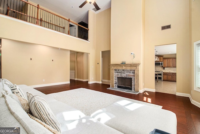 10 Ridgeview Ct, Newnan, GA 30263 - bedroom featuring a towering ceiling, dark wood-style flooring, and a fireplace