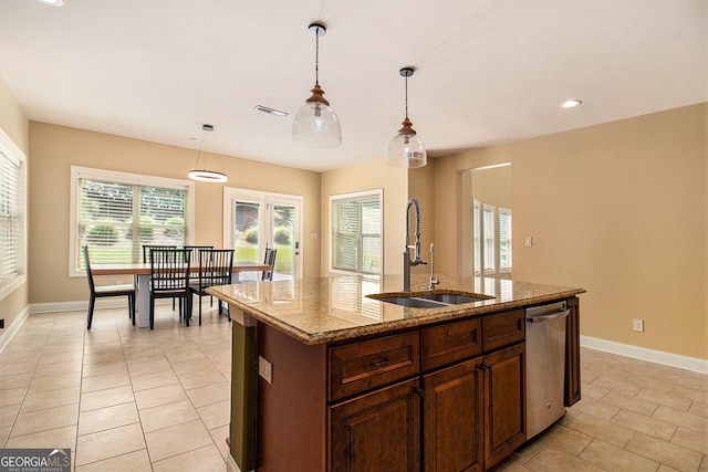 10 Ridgeview Ct, Newnan, GA 30263 - kitchen with dishwasher, a center island with sink, hanging light fixtures, light stone counters, and light tile patterned floors