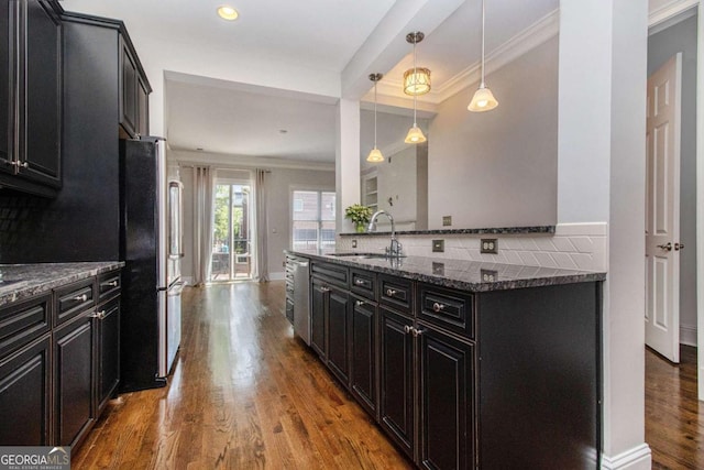 1836 Preserve Way, Brookhaven, GA 30341 - kitchen featuring appliances with stainless steel finishes, ornamental molding, dark cabinetry, tasteful backsplash, and wood finished floors