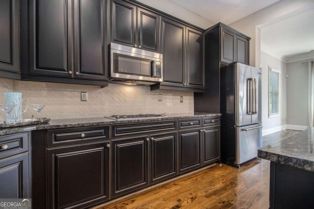 1836 Preserve Way, Brookhaven, GA 30341 - kitchen with appliances with stainless steel finishes, crown molding, dark wood-type flooring, tasteful backsplash, and dark cabinets