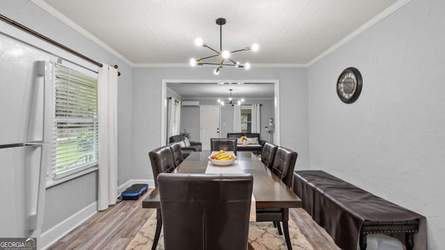 5599 Redan Cir, Stone Mountain, GA 30088 - dining space featuring a chandelier, wood finished floors, an AC wall unit, and ornamental molding