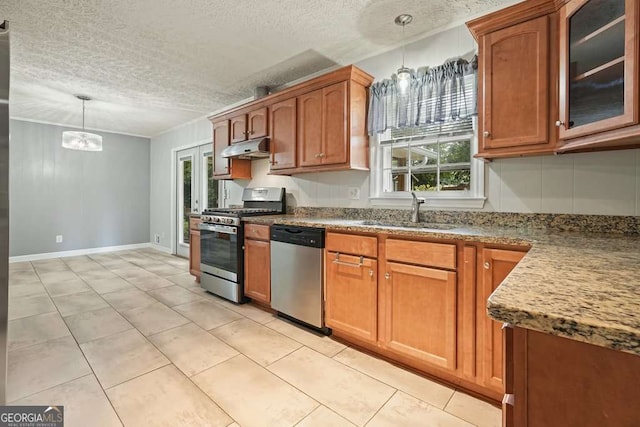 4212 Worth St NW, Acworth, GA 30101 - kitchen featuring appliances with stainless steel finishes, under cabinet range hood, a textured ceiling, brown cabinets, and glass insert cabinets