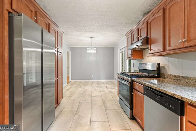 4212 Worth St NW, Acworth, GA 30101 - kitchen with appliances with stainless steel finishes, under cabinet range hood, a textured ceiling, light stone counters, and light tile patterned flooring