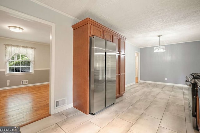 4212 Worth St NW, Acworth, GA 30101 - kitchen featuring stainless steel appliances, ornamental molding, decorative light fixtures, a chandelier, and brown cabinetry