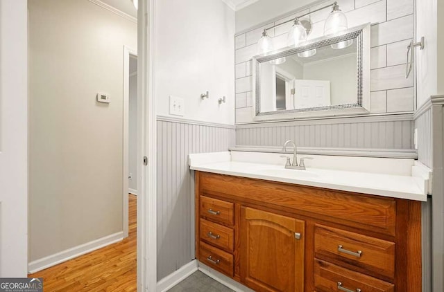 4212 Worth St NW, Acworth, GA 30101 - bathroom with crown molding, vanity, wood finished floors, and wainscoting