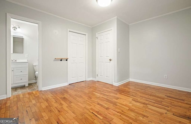 4212 Worth St NW, Acworth, GA 30101 - unfurnished bedroom with light wood-style floors, crown molding, a closet, and ensuite bath