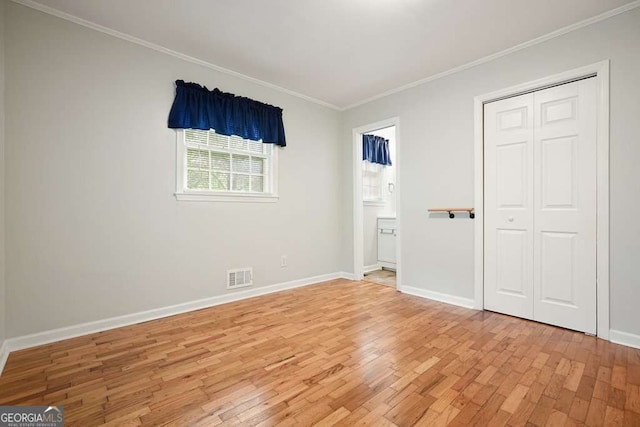 4212 Worth St NW, Acworth, GA 30101 - unfurnished bedroom with light wood-style flooring, ornamental molding, ensuite bathroom, and a closet