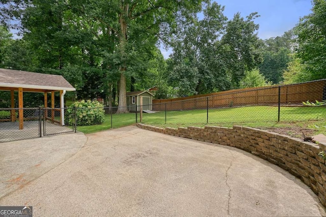 4212 Worth St NW, Acworth, GA 30101 - view of patio / terrace with a gate, a storage unit, and view of wooded area